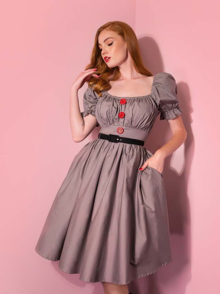 With her hand in her pocket, Emily models the Pennywise babydoll dress from Vixen Clothing.