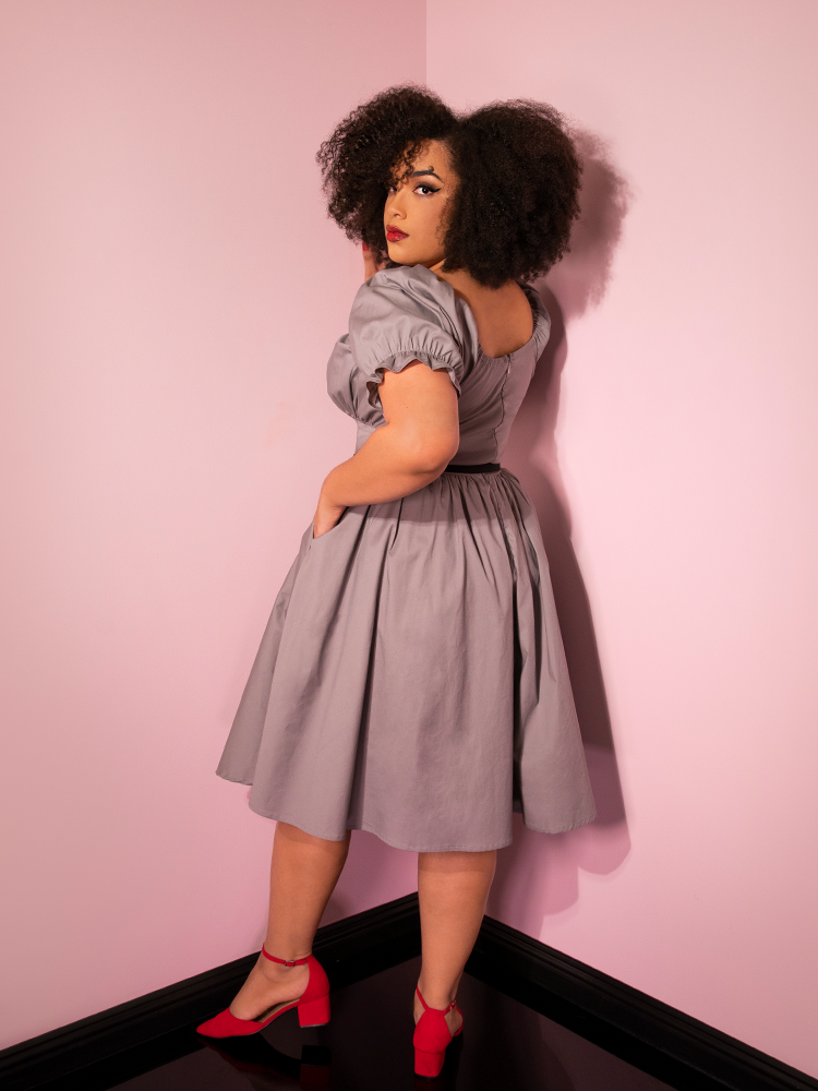 Looking over her shoulder, Ashleeta models the Pennywise babydoll dress from Vixen Clothing.