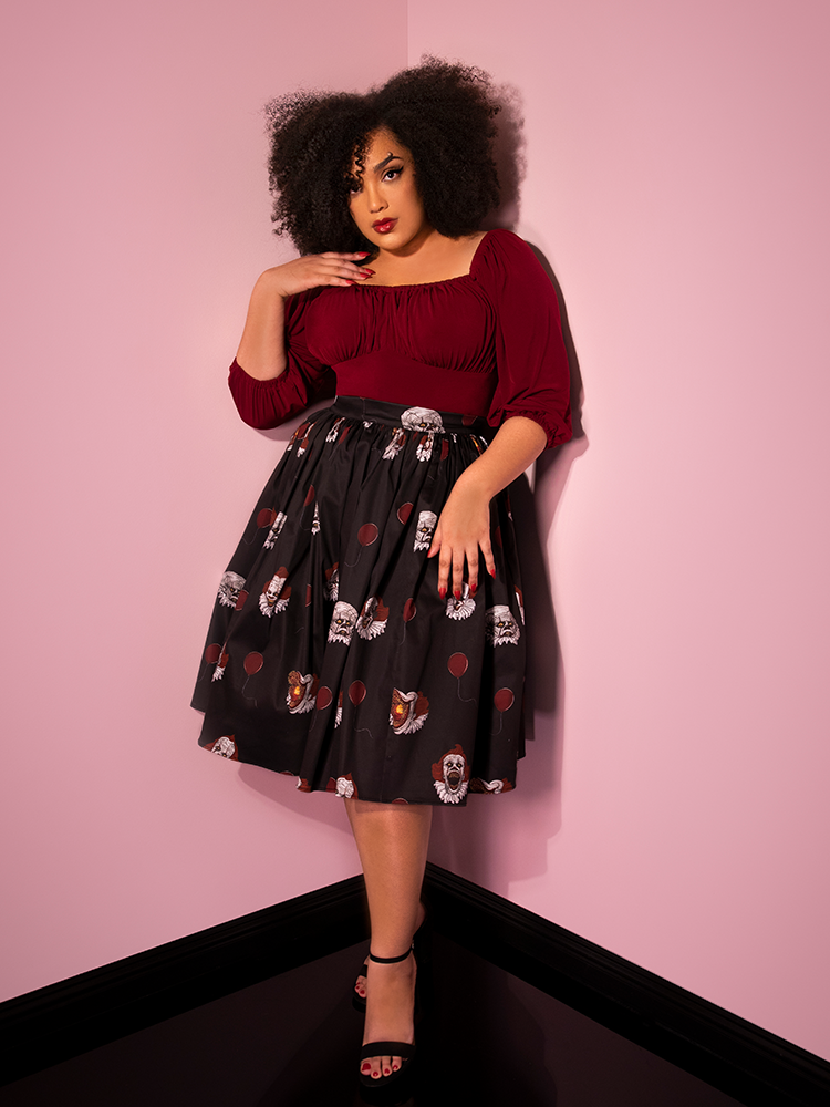 A full length photo of Ashleeta modeling the Pennywise swing skirt in black by Vixen Clothing.