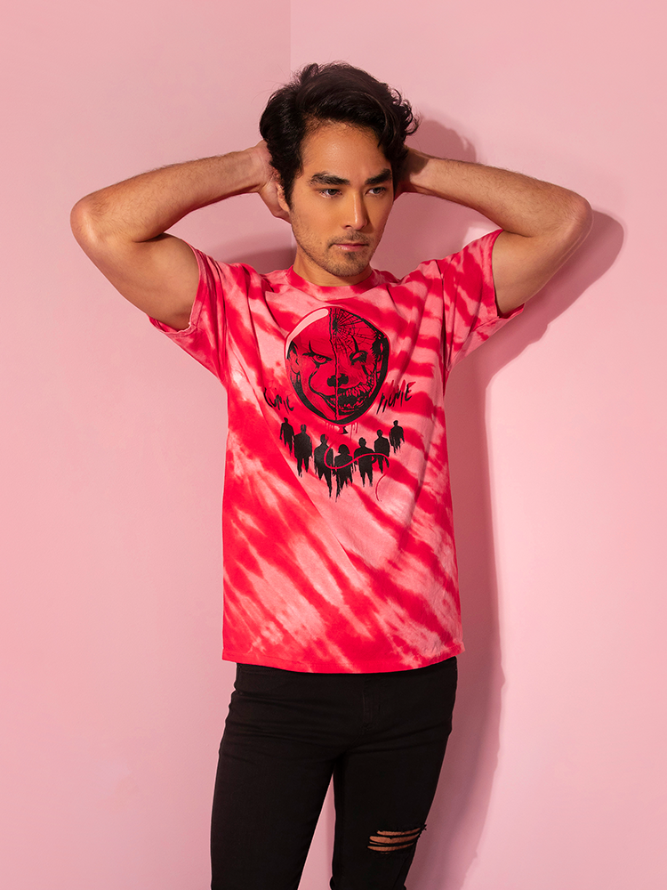 With his hands behind his head, model Ethan shows off the Come Home red tie dye tee by Vixen Clothing.