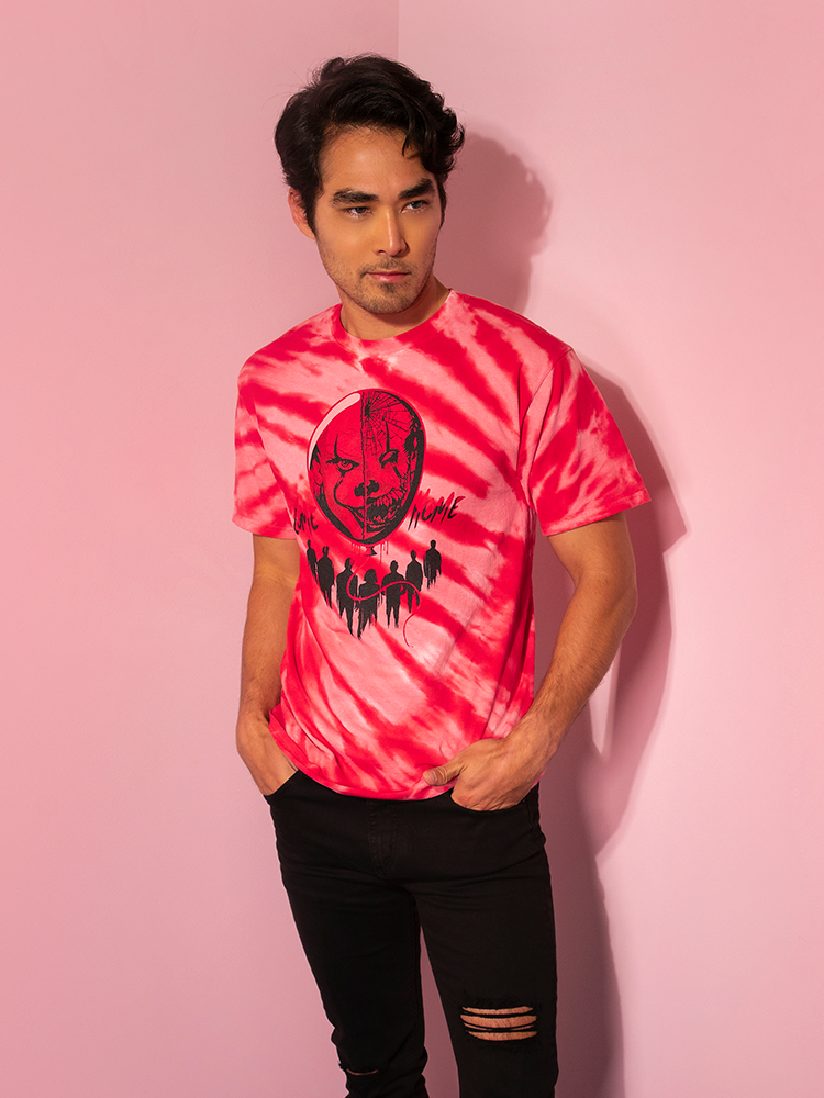 With his hands in his pockets and looking off camera, Ethan models the Come Home red tie dye tee by Vixen Clothing.