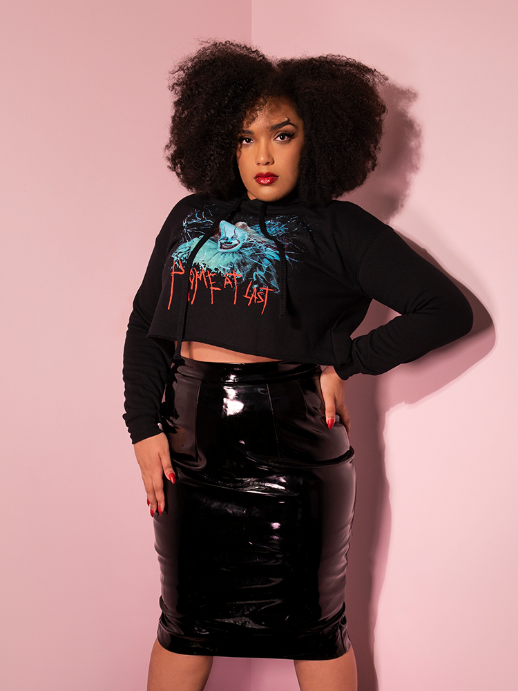 With her hands on her hips, Ashleeta models the Home At Last cropped hoodie by Vixen Clothing.