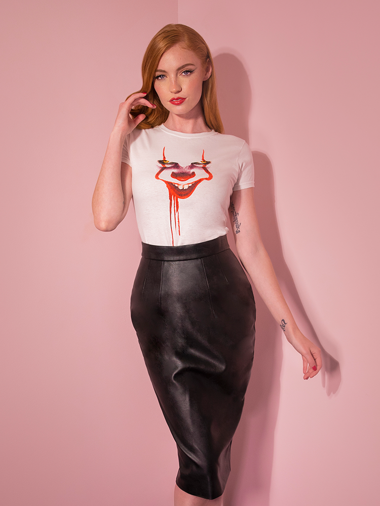 With her hand in her hair, Emily models the Pennywise poster art tee by Vixen Clothing.
