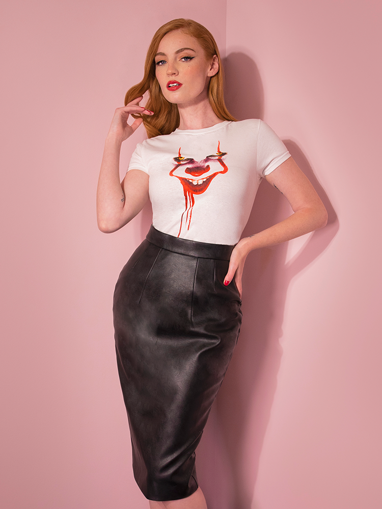 With her hand on her hip, Emily shows off the Pennywise poster art tee by Vixen Clothing.