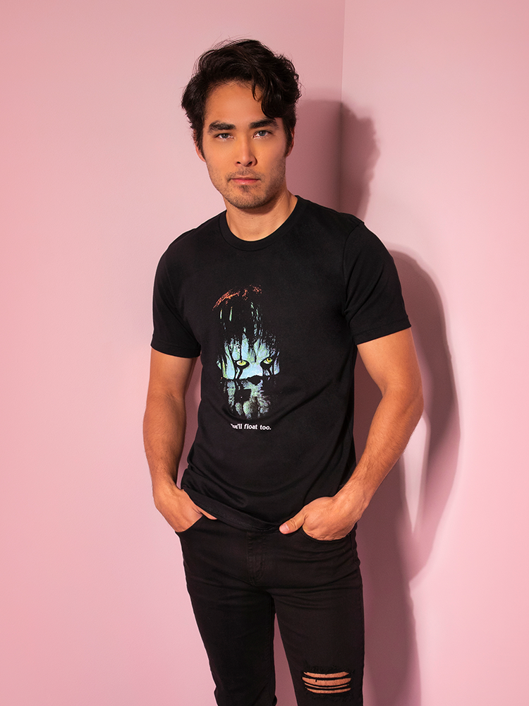 Looking at the camera with his hands in his pockets, Ethan models the Pennywise float tee by Vixen Clothing.