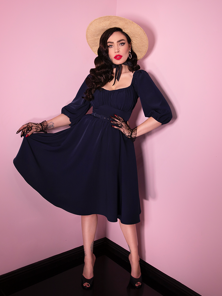A full-body shot of Micheline Pitt wearing the Vacation Dress in Navy Blue.