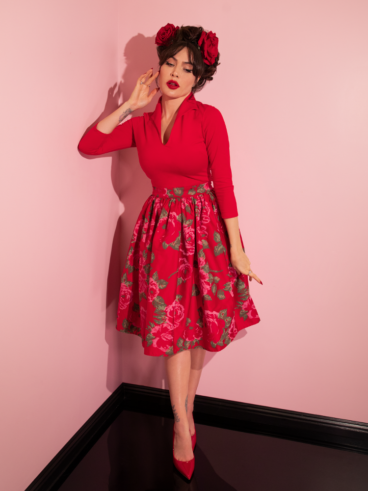 Brunette model wearing a retro style red top and matching pencil skirt.