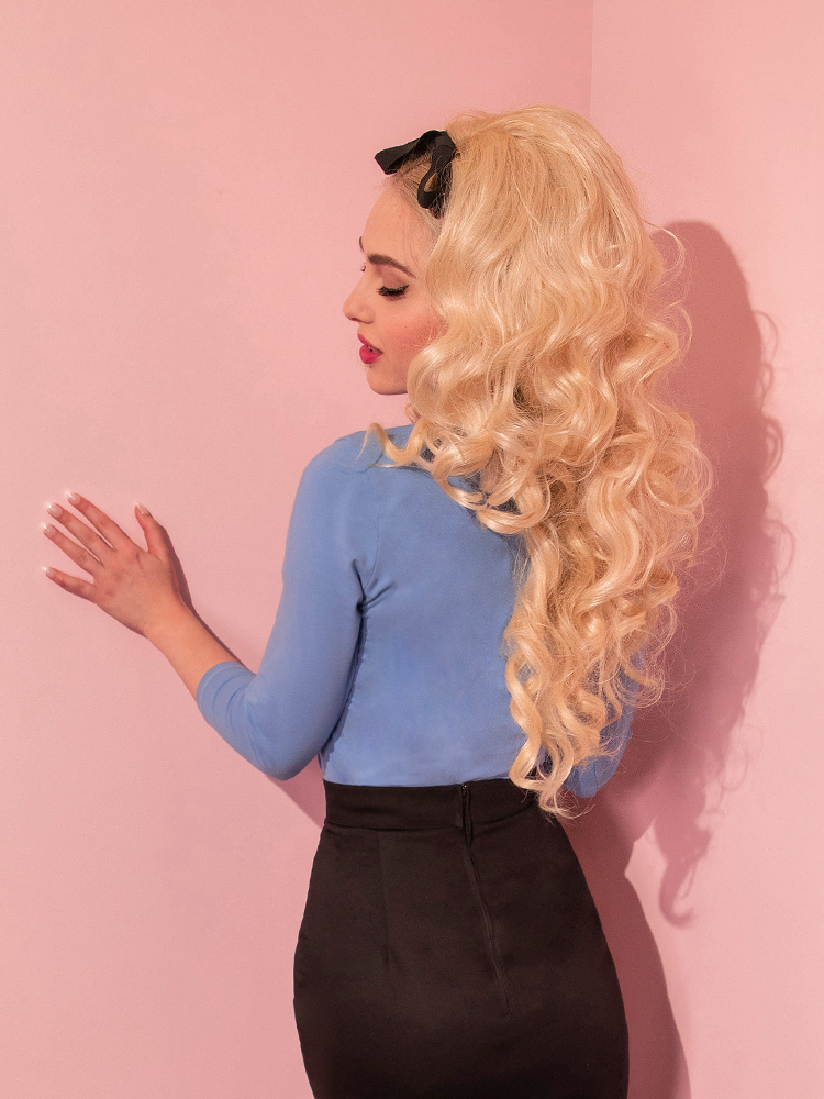 Blonde model turned away from the camera showing the back of the Vixen Top in Sunset Blue.
