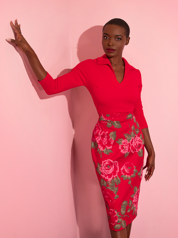 Brittany poses in an all red outfit highlighted by the Vixen Pencil Skirt in Vintage Red Rose Print.