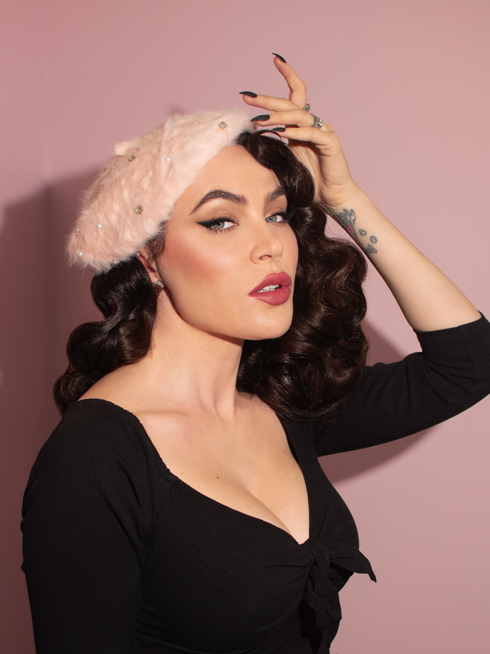 Portrait shot of Micheline Pitt wearing the Vintage Style Beret with Rhinestones in Petal Pink from Vixen Clothing.