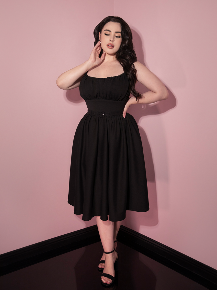 Rachel Sedory posing in a black retro style dress from Vixen Clothing.